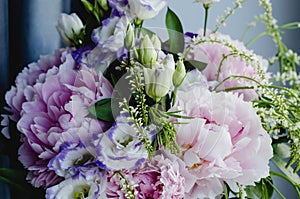 Rich bunch of pink peonies peony and lilac eustoma roses flowers. Rustic style, still life. Fresh spring bouquet, pastel colors. B