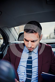 Rich businessman driving in a limo