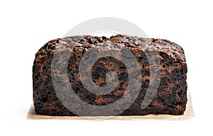 Rich dark fruit cake isolated on white