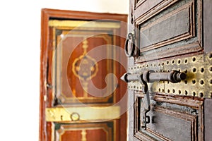 Rich decorated wooden door with lock inside of the Bahia Palace, Marrkesh, Morocco