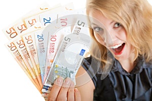 Rich happy business woman showing euro currency money banknotes