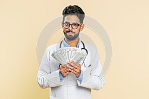 Rich happy doctor man winner waving money dollar cash like a fan, big income wealth success business