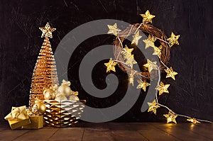 Rich  home interior - golden decoration for christmas - christmas tree, glowing lights, stars, wreath, balls, gift box, ribbons.