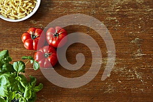 Rich kitchen scene with tomatoes herbs and pasta