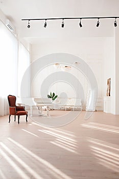 Rich luxury interior of a classic style room with vintage furniture, big windows, mirror, chandeliers and grand piano. photo