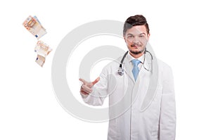 Rich male doctor drop bancknotes of euro