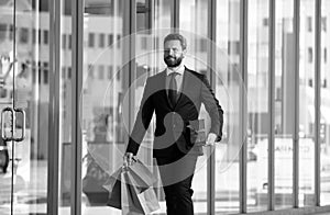 Rich man. Business man shopping in a shopping center. Happy businessman in suit holding paperbags. Shopaholic man