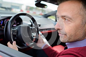 rich man driving sports car