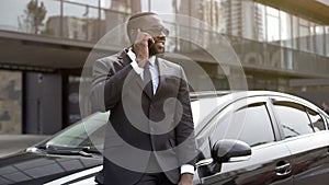 Rich man talking on phone with smile on face, happy groom on wedding day