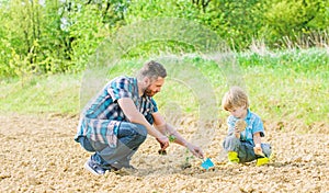 Rich natural soil. Eco farm. happy earth day. Family tree. new life. soils and fertilizers. small boy child help father