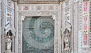 The rich ornate entrance to the Duomo in Florence Italy.