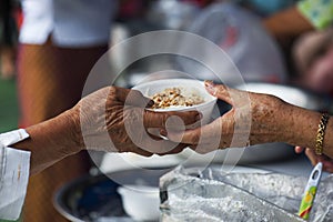 Rich people give food to the poor. starvation concept photo