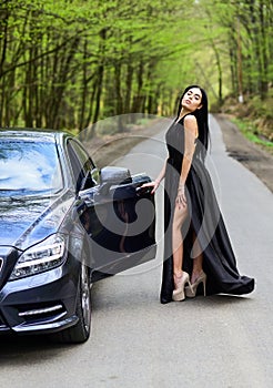 Rich people lifestyle. Start journey. Buy expensive auto. Symbol of richness. Luxury car. Auto and pretty sexy woman at