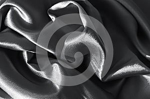 Rich Rich black and white grey satin folded fabric texture. Abstract background for design