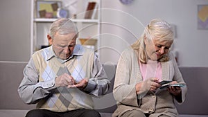 Rich senior woman counting dollars, poor old man holding coins in hand, society