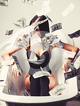 Rich sexy woman lies on money. Currency, women, winning. Sexy female and dollar bills. Woman with lot of money