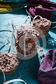 Rich sweet crumble Christmas mini chocolate cakes on vibrant eastern turquoise background
