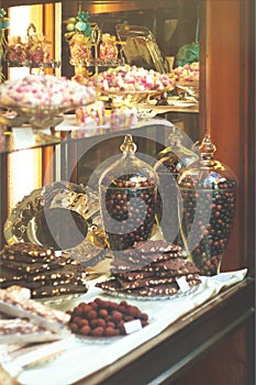 Rich variety of chocolates and candies in display window of ita
