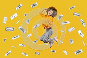 Rich woman jumping in money rain, celebrating her victory, clenched fists and screaming happily.