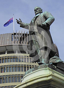 Bronze statue of prime minister pointing to flag