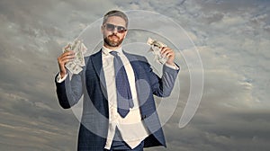 riches of man with money on sky background with copy space. riches of man with money outdoor