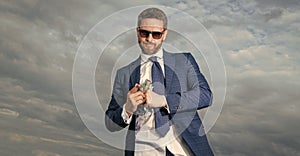 riches photo of man with dollar money. riches of man with money on sky background