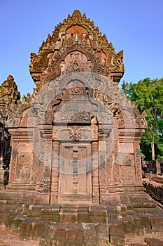 Richly decorated entrance door of Temple Banteay Srei, Cambodia. Carvings from Hindu mythology on walls Banteay Srei, Angkor Wat.