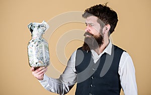Richness and wellbeing. Security and cash money savings. Banking concept. General savings tips. Man bearded hipster hold