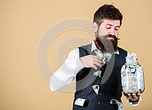 Richness and wellbeing. Security and money savings. Banking concept. Man bearded guy hold jar full of cash savings. Safe