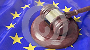 Judge`s gavel lies on top of the EU flag