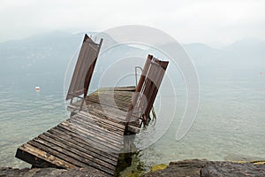 The rickety gangway on a shore of a mountain lake