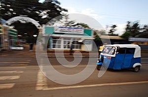 Rickshaw driving through the town of Ambo, Ethiopia photo