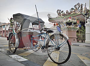 Rickshaw and Temple in old penang street
