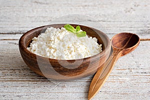 Ricotta cheese, curd cheese, farmers cheese or tvorog in wooden bowl photo