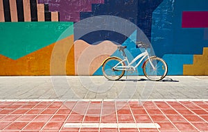 Ride bike stop in the city on the wall of many colors. Cycling or commuting in the urban environment, ecological transport concept