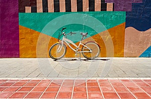 Ride bike stop in the city on the wall of many colors. Cycling or commuting in the urban environment, ecological transport concept