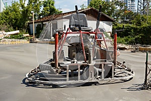 Ride on dual power trowel machine over freshly polished concrete slab