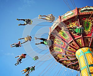 Ride at fair spinning around with people having fun