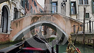 A ride in a gondola under the small bridges in Venice