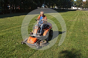 Ride-on lawn mower cutting grass.