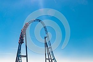 Ride roller coaster in blurred motion on sky background in amusement park