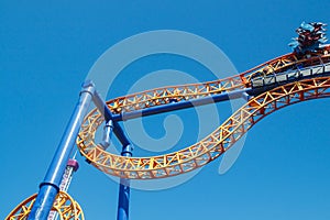 Ride roller coaster in blurred motion on sky background in amusement park