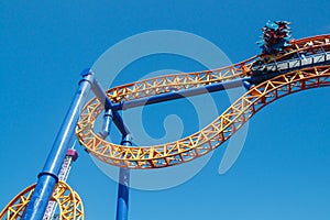 Ride roller coaster in blurred motion on sky background in amusement park