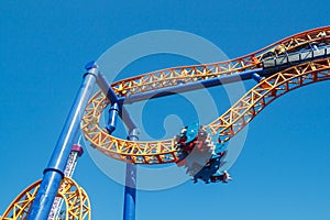 Ride roller coaster in blurred motion on sky background in amusement park