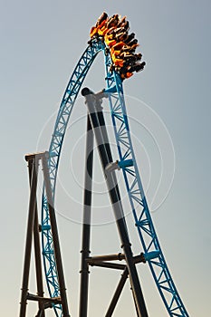 Ride roller coaster in blurred motion on sky background in amusement park