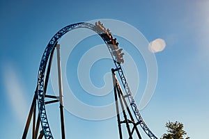 Ride roller coaster in blurred motion on sky background in amusement park