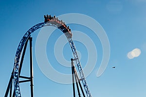 Ride roller coaster in blurred motion on sky background in amusement park