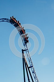 Ride roller coaster in blurred motion on sky background in amusement park