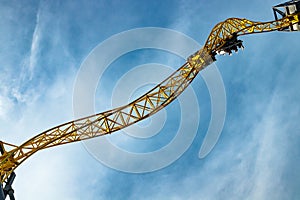 Ride roller coaster in motion in amusement park on blue sky background