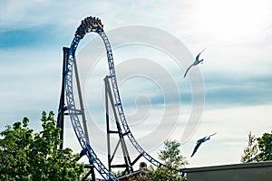 Ride roller coaster in motion on sky background in amusement park